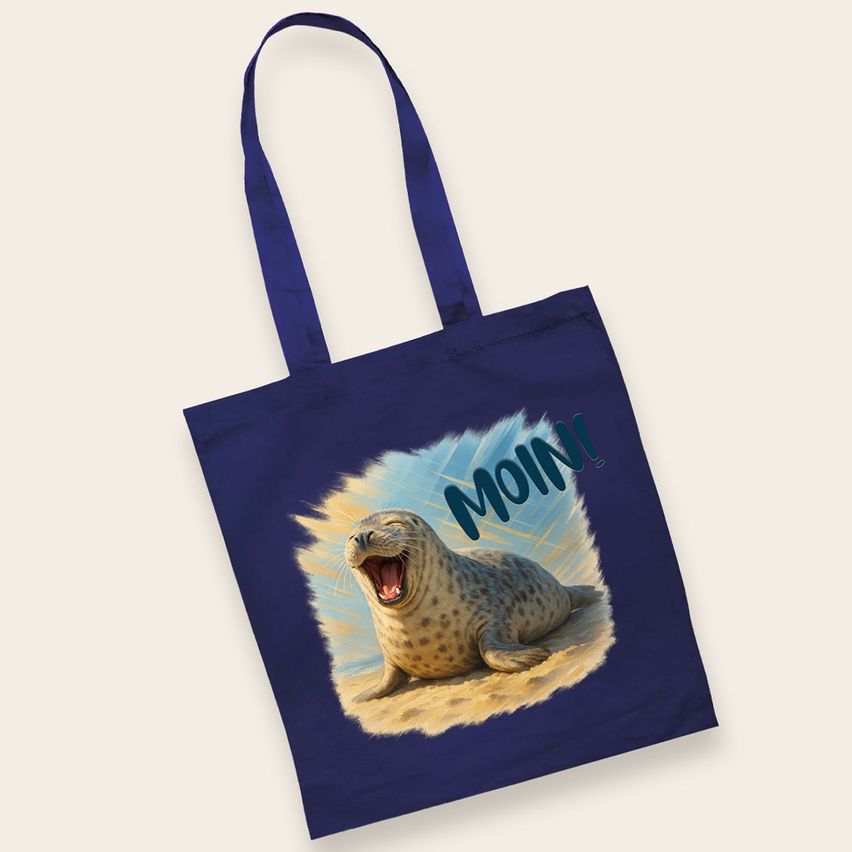 Dunkelblaue Baumwolltasche mit langen Henkeln, bedruckt mit einer lachenden Robbe und dem Gruß Moin.