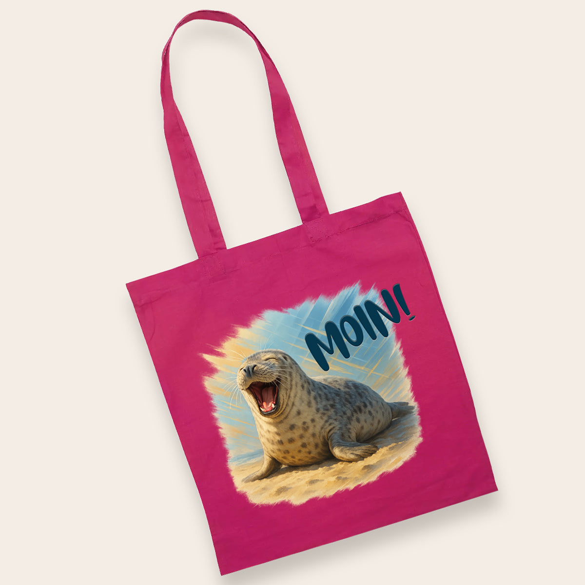 Knallpinke Baumwolltasche mit lachender Robbe und Moin-Schriftzug – ein farbenfroher Begleiter für unterwegs.